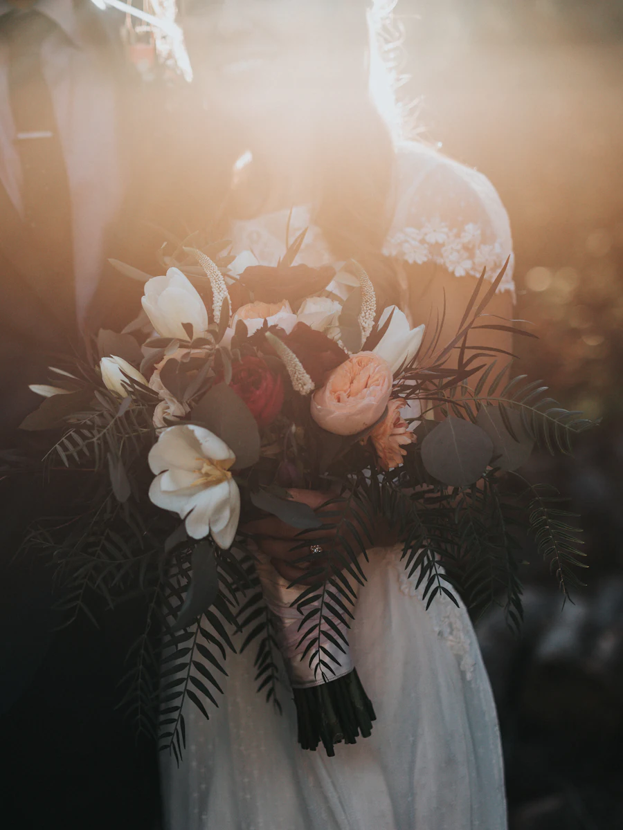 A bride holding a bouquet in soft light