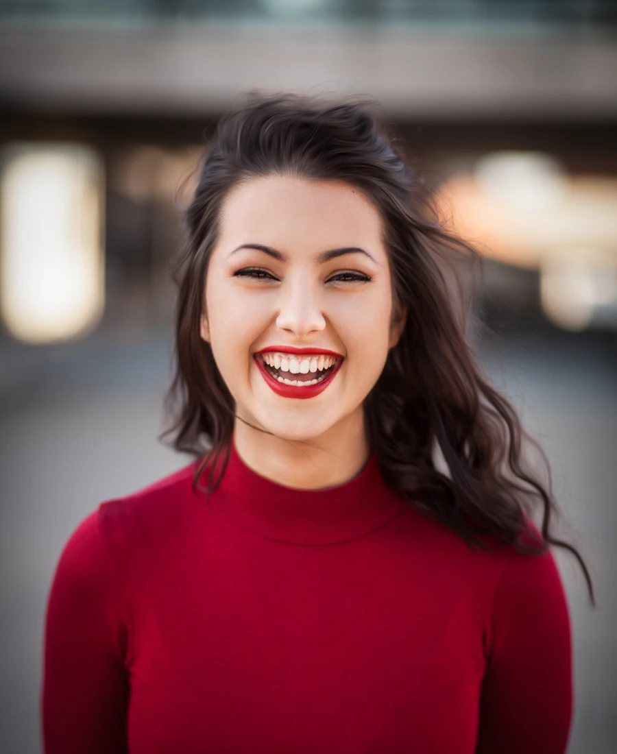 A smiling woman in a red sweater